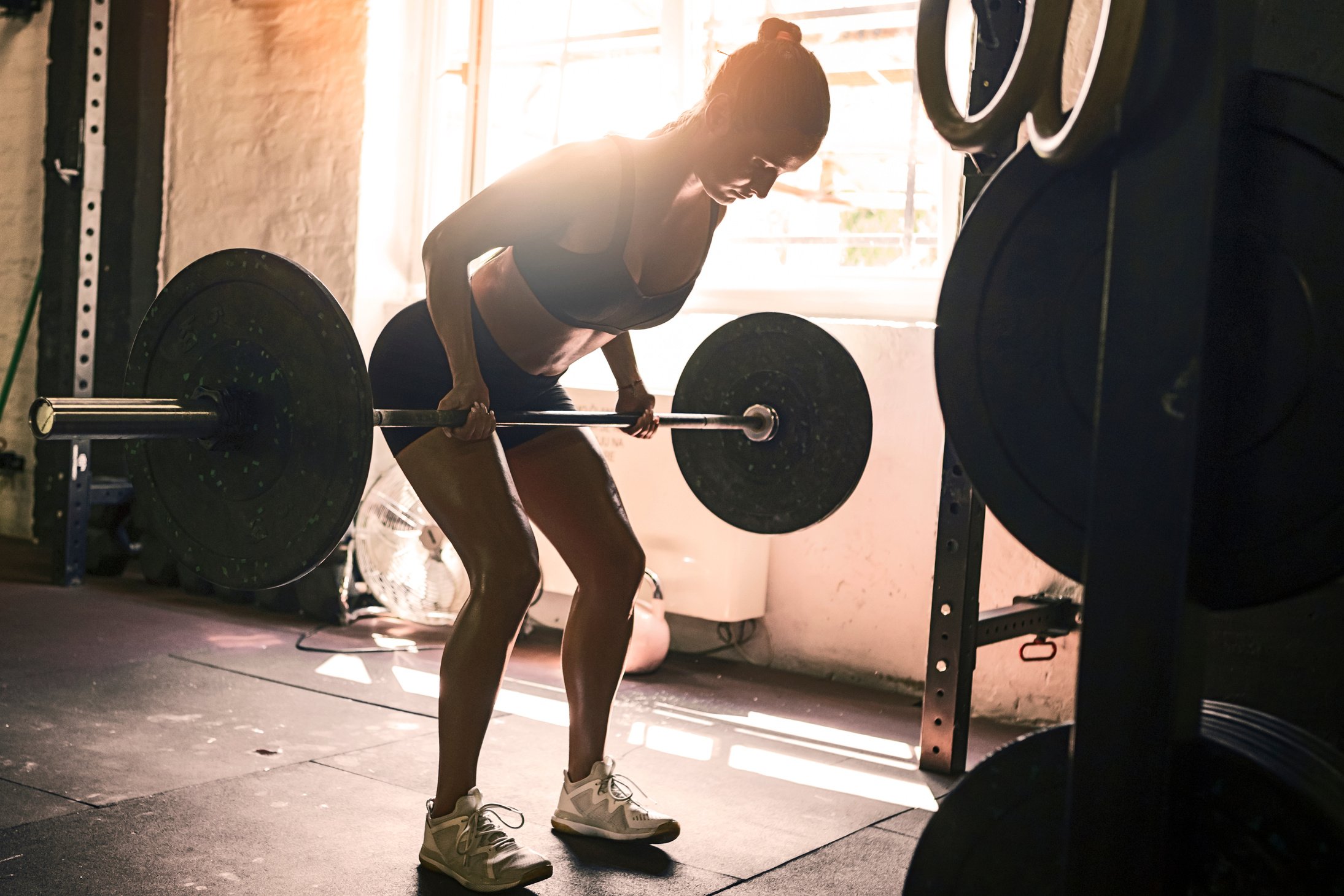 Young woman lifting weights